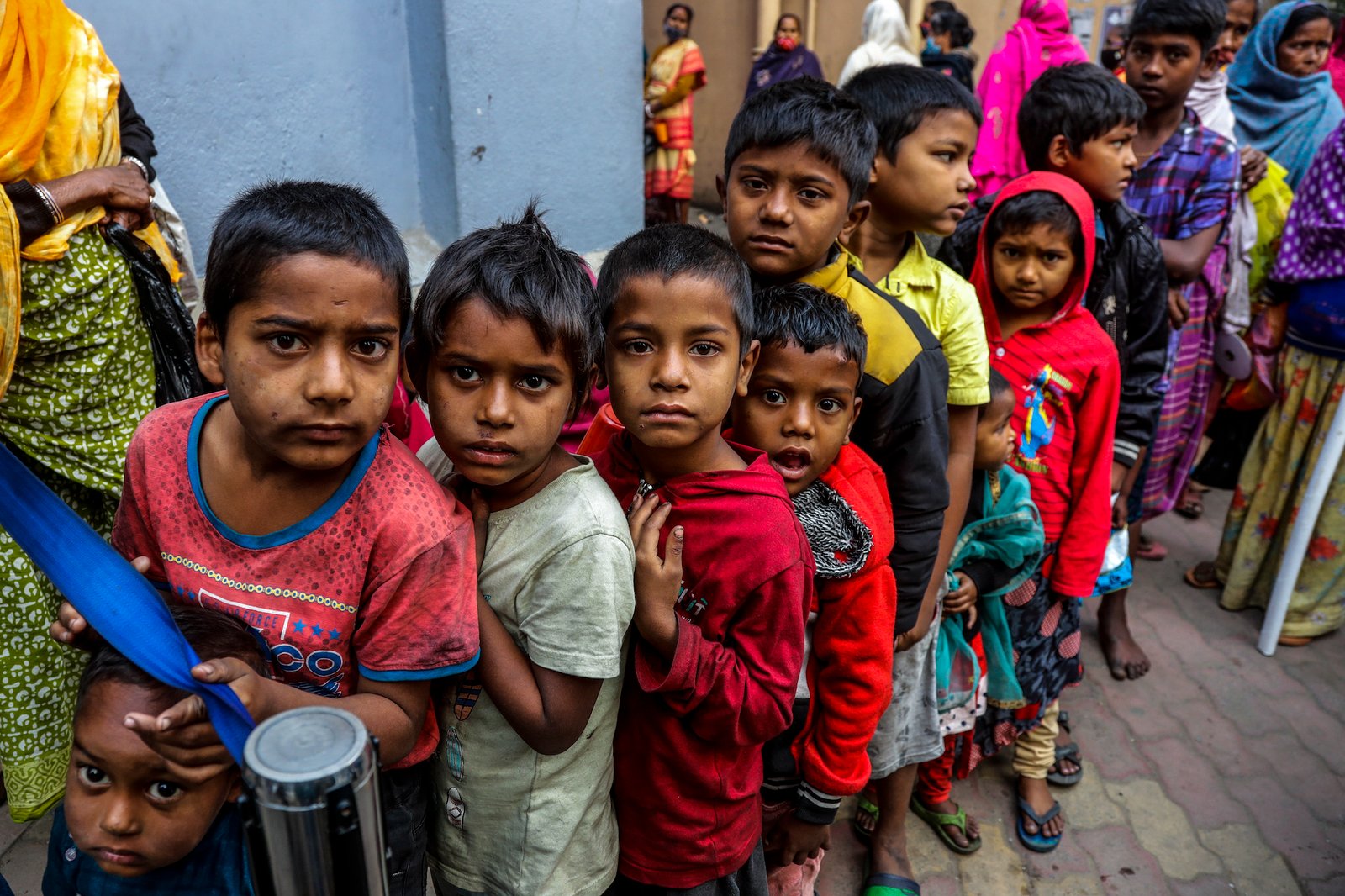 Homeless children stand in a queue to receive morning meal from Missionaries of Charity, the order founded by Saint Teresa, at the headquarter in Kolkata, India, Tuesday, Dec. 28, 2021. (AP Photo/Bikas Das)